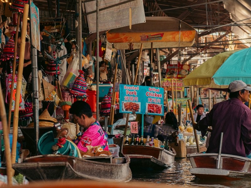 Vendors selling food from boats at a floating market